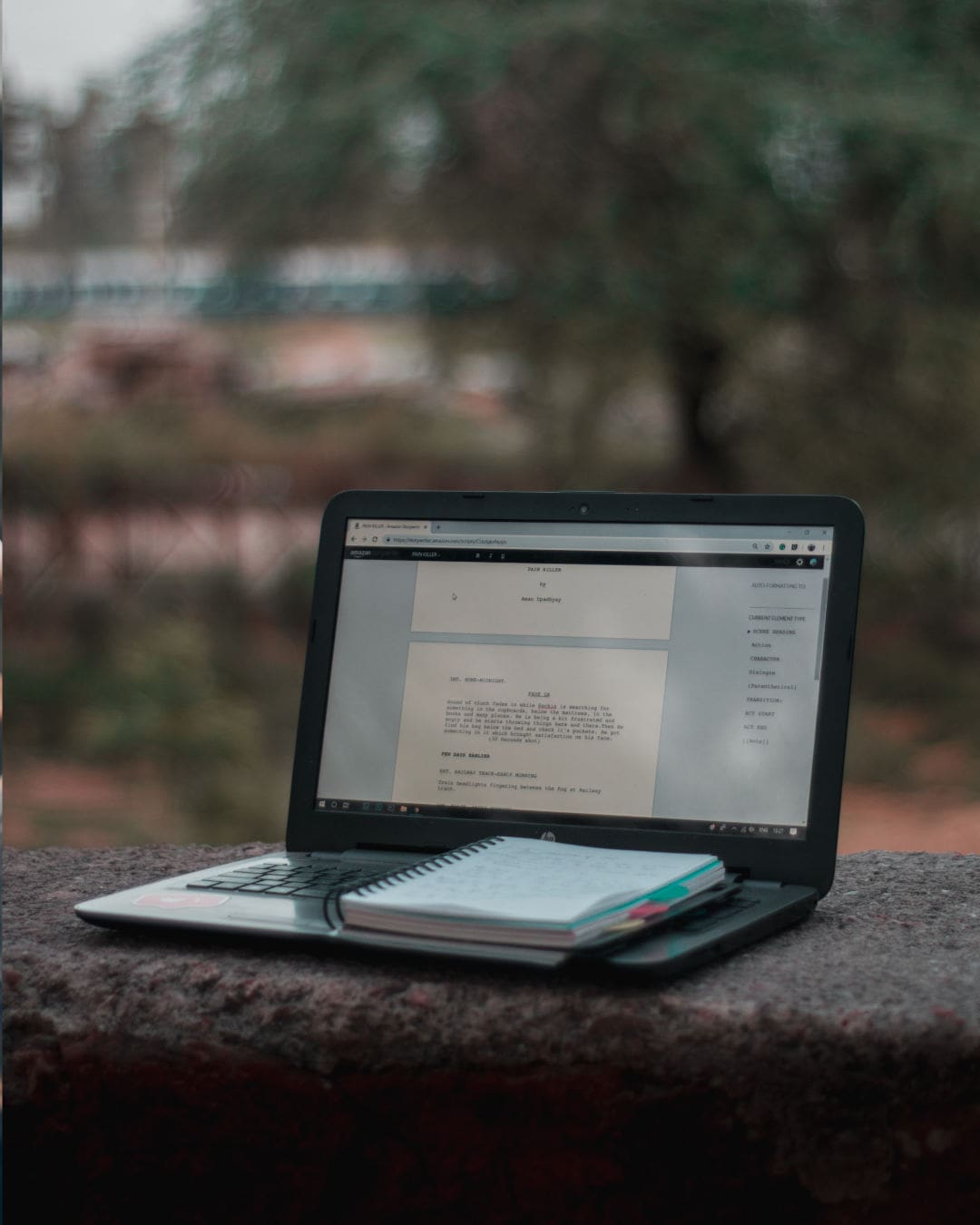 An actor using script analysis techniques with a laptop and a notepad