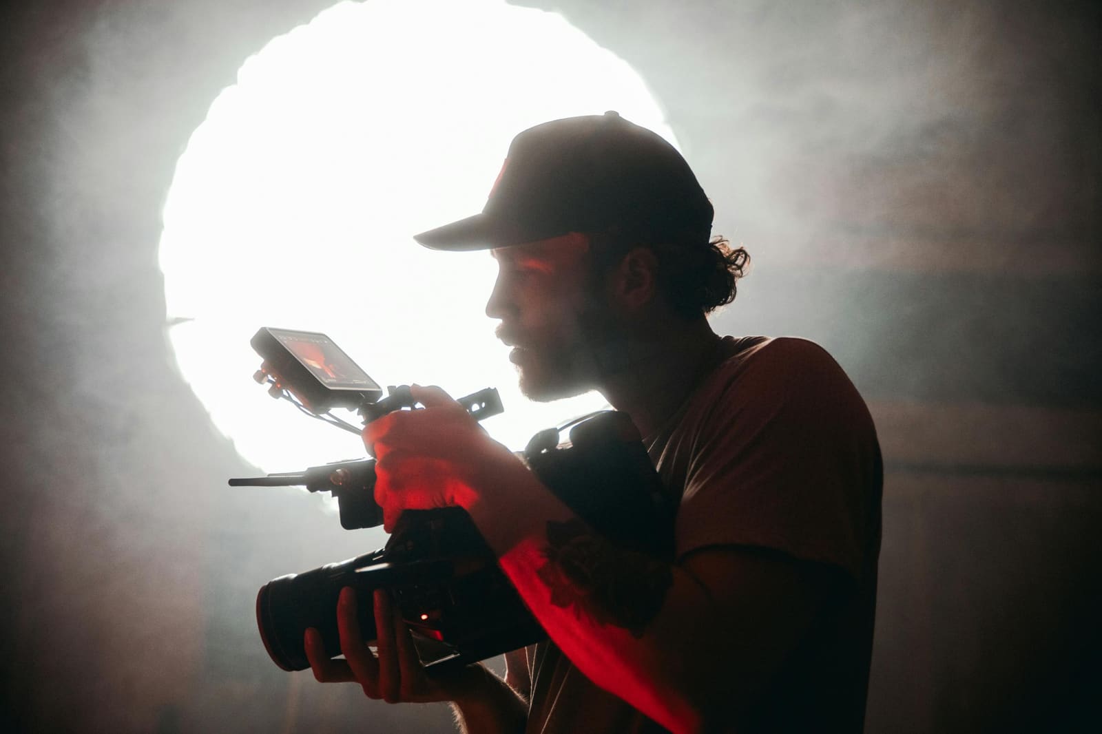 A filmmaker on his first day in a new role, standing on set with a camera crew in the background.