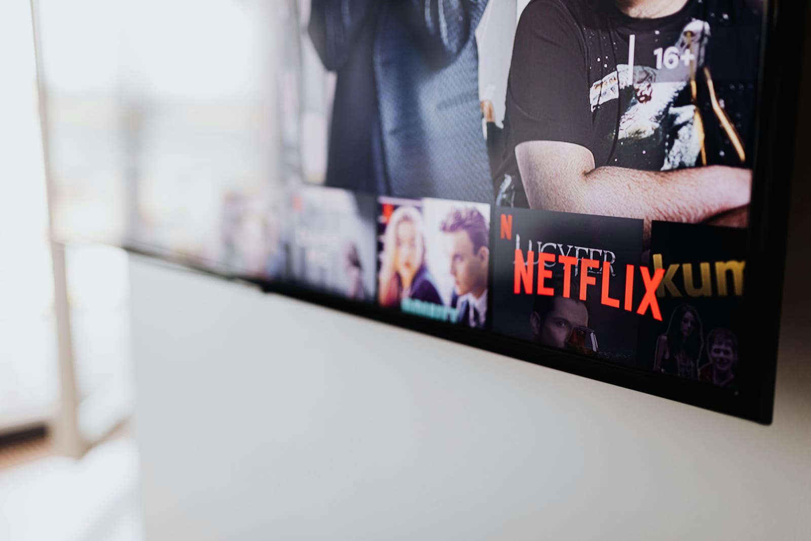 A filmmaker watching a film on a streaming platform at home, representing how streaming platforms have changed film storytelling and audience viewing habits.