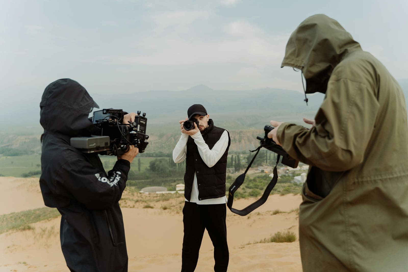 Group of independent filmmakers collaborating outdoors with cameras and equipment, representing the power of local film networks for filmmakers.