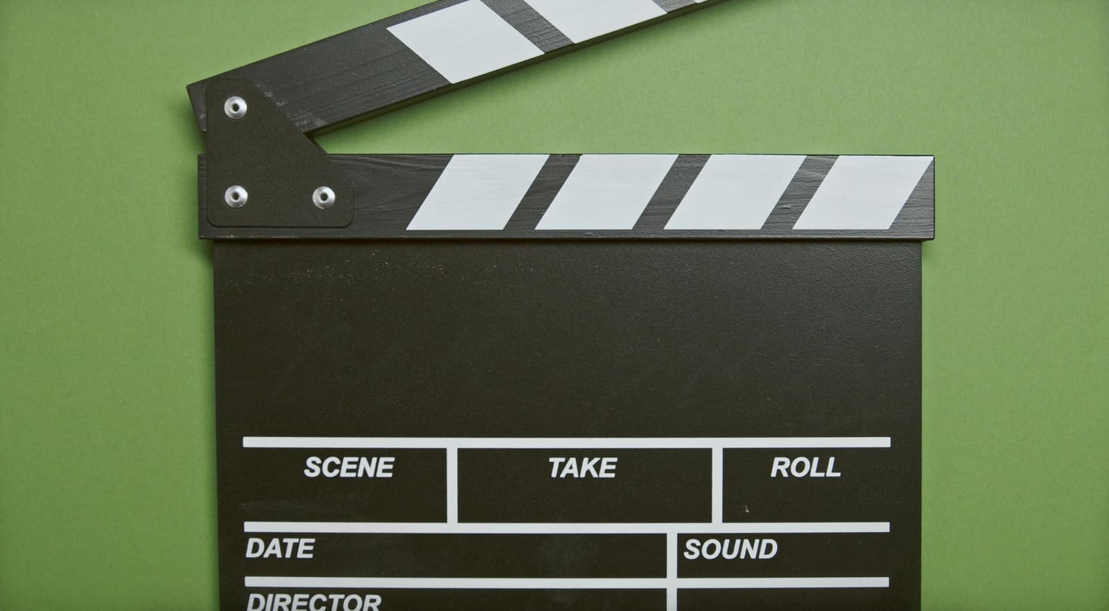 Beginner filmmaker directing actors while filming a short movie on a small set, illustrating how to make a short film step by step for beginners.